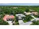 Scenic aerial of a residential community, showcasing its lush greenery, diverse homes, and inviting atmosphere at 3738 Eagle Hammock Dr, Sarasota, FL 34240