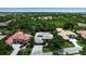Beautiful neighborhood with well-manicured lawns, mature trees, and charming homes, as seen from above at 3738 Eagle Hammock Dr, Sarasota, FL 34240