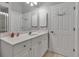 Bright bathroom with double door and vanity with white countertop and cabinetry at 3738 Eagle Hammock Dr, Sarasota, FL 34240