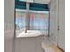 Bright bathroom featuring a sink with a mirror and a shower with colorful curtains, creating a clean and inviting atmosphere at 3738 Eagle Hammock Dr, Sarasota, FL 34240
