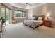 Bright bedroom featuring a tray ceiling, a large window, and access to the screened outdoor area at 3738 Eagle Hammock Dr, Sarasota, FL 34240