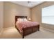 Cozy bedroom featuring a ceiling fan, large window, and neutral color scheme at 3738 Eagle Hammock Dr, Sarasota, FL 34240