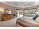 Spacious bedroom featuring a tray ceiling, a dresser, and access to a screened outdoor area at 3738 Eagle Hammock Dr, Sarasota, FL 34240
