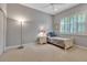 Comfortable bedroom featuring a bed with a nightstand, ceiling fan and a window, showcasing a functional and relaxing space at 3738 Eagle Hammock Dr, Sarasota, FL 34240