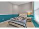 Cozy bedroom featuring a bed with a decorative quilt, a nightstand, and a window, showcasing a comfortable and inviting space at 3738 Eagle Hammock Dr, Sarasota, FL 34240