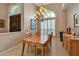 Dining room with wood table set, shuttered windows, chandelier, and tile flooring at 3738 Eagle Hammock Dr, Sarasota, FL 34240