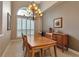 Spacious dining room with a wooden table, a chandelier, and plenty of natural light at 3738 Eagle Hammock Dr, Sarasota, FL 34240