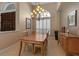 Bright dining room with wooden table and chairs illuminated by decorative chandelier at 3738 Eagle Hammock Dr, Sarasota, FL 34240