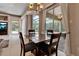 Bright dining room with a granite-topped table and view of the outdoor pool and patio at 3738 Eagle Hammock Dr, Sarasota, FL 34240