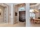 Bright foyer features tile floors and decorative columns, leading to dining area at 3738 Eagle Hammock Dr, Sarasota, FL 34240