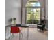 Bright home office with a large window, desk, and comfortable chair perfect for working remotely at 3738 Eagle Hammock Dr, Sarasota, FL 34240