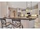 Open kitchen with granite countertops and seating, stainless steel appliances, and white cabinets at 3738 Eagle Hammock Dr, Sarasota, FL 34240