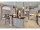 Inviting kitchen with granite counters, stainless steel appliances, and arched doorway at 3738 Eagle Hammock Dr, Sarasota, FL 34240