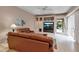 Inviting living room with leather sofas and a built-in entertainment center, with access to the patio at 3738 Eagle Hammock Dr, Sarasota, FL 34240