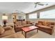 Open living room featuring comfortable sofas, natural light, and neutral decor at 3738 Eagle Hammock Dr, Sarasota, FL 34240