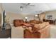 Spacious living room with multiple seating areas and ceiling fans at 3738 Eagle Hammock Dr, Sarasota, FL 34240