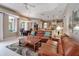 Open-concept living room with leather sofas, a dining area, and a view into the modern kitchen at 3738 Eagle Hammock Dr, Sarasota, FL 34240