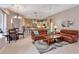 Spacious living room flowing into dining area with leather sofas and access to a modern kitchen at 3738 Eagle Hammock Dr, Sarasota, FL 34240