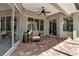 Covered patio with brick flooring, ceiling fan, and comfortable seating, perfect for outdoor relaxation and entertaining at 3738 Eagle Hammock Dr, Sarasota, FL 34240