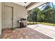 Spacious outdoor patio with grill and screened enclosure, offering an ideal space for barbecues and outdoor dining at 3738 Eagle Hammock Dr, Sarasota, FL 34240