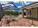 Screened-in patio with dining area, tile floor, ceiling fan and view of the pool at 3738 Eagle Hammock Dr, Sarasota, FL 34240