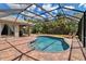 Screened-in pool with patio, grill, and manicured landscaping offering a private outdoor retreat at 3738 Eagle Hammock Dr, Sarasota, FL 34240
