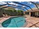 Screened-in pool area with a brick patio and lounge chairs, perfect for relaxing at 3738 Eagle Hammock Dr, Sarasota, FL 34240