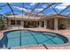 A serene pool area enclosed by a screen, complemented by a brick patio at 3738 Eagle Hammock Dr, Sarasota, FL 34240