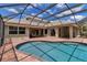 Screened-in pool with brick patio, sliders to home, outdoor seating, and covered grill area at 3738 Eagle Hammock Dr, Sarasota, FL 34240