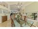 Inviting dining space with a glass-top table, and seamless access to the living area at 410 Wellington, Venice, FL 34292
