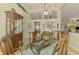Formal dining room with glass table, chandelier, and built-in china cabinet at 410 Wellington, Venice, FL 34292