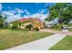 Well-kept home with mature landscaping, sidewalks and a red tile roof in a suburban setting at 410 Wellington, Venice, FL 34292