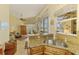 Kitchen bar top overlooking living area and out to screened patio with scenic lake view at 410 Wellington, Venice, FL 34292