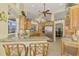 Bright kitchen with granite countertops, stainless steel appliances, and custom wood cabinetry at 410 Wellington, Venice, FL 34292