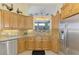 Galley style kitchen featuring custom cabinets and modern stainless steel appliances at 410 Wellington, Venice, FL 34292