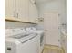 A functional laundry room with modern washer and dryer and plenty of storage at 410 Wellington, Venice, FL 34292