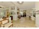Open living area featuring tile flooring, a decorative wall, and seamless access to outdoor spaces at 410 Wellington, Venice, FL 34292