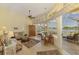Bright living room with water view, tile floor, and seamless access to screened patio at 410 Wellington, Venice, FL 34292