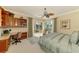 Comfortable bedroom showcasing built-in bookshelves, a desk, and sliding glass doors to the pool area at 410 Wellington, Venice, FL 34292