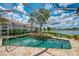 Backyard pool and spa, surrounded by lush landscaping and an enclosed patio screen at 410 Wellington, Venice, FL 34292