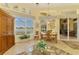 Sunroom with waterfront views from many windows, a seating area, and access to the outdoor living spaces at 410 Wellington, Venice, FL 34292