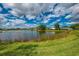Waterfront view of calm water, lush green lawn and blue sky at 410 Wellington, Venice, FL 34292