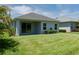 A serene backyard with a covered patio, lush green lawn, and well-maintained landscaping at 4318 Deep Creek Ter, Parrish, FL 34219