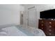 Comfortable bedroom featuring a dresser with a television and a closet at 4318 Deep Creek Ter, Parrish, FL 34219