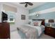 Cozy bedroom featuring a blue and white color scheme, a ceiling fan, and a comfortable bed at 4318 Deep Creek Ter, Parrish, FL 34219