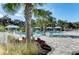 Community pool area with covered cabanas, lounge chairs, and lush landscaping for a relaxing atmosphere at 4318 Deep Creek Ter, Parrish, FL 34219