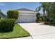 Well-maintained two-car garage with a concrete driveway and attractive landscaping at 4318 Deep Creek Ter, Parrish, FL 34219