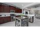Well-appointed kitchen with stainless steel appliances, dark cabinets, and an island table with bar stool seating at 4318 Deep Creek Ter, Parrish, FL 34219