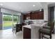 Charming kitchen featuring dark cabinetry, white countertops, stainless steel appliances, and outdoor access at 4318 Deep Creek Ter, Parrish, FL 34219