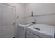 Bright laundry room with modern washer and dryer, plus wire shelving at 4318 Deep Creek Ter, Parrish, FL 34219